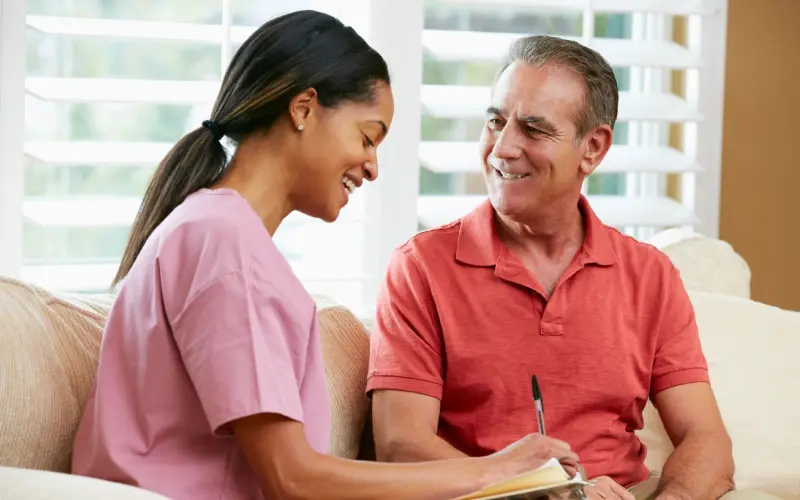 A man and woman are smiling while looking at each other.